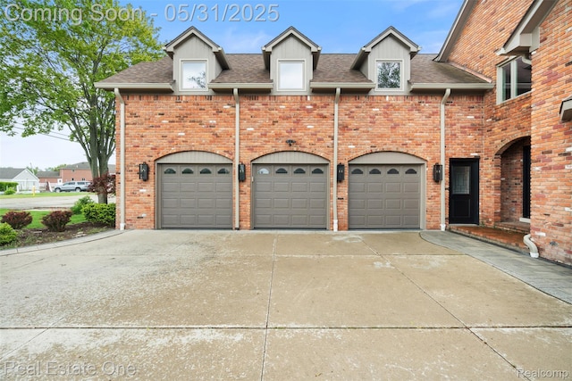 48556 Harbor Dr, Chesterfield, MI 48047 - view of front facade with concrete driveway, an attached garage, brick siding, and a shingled roof