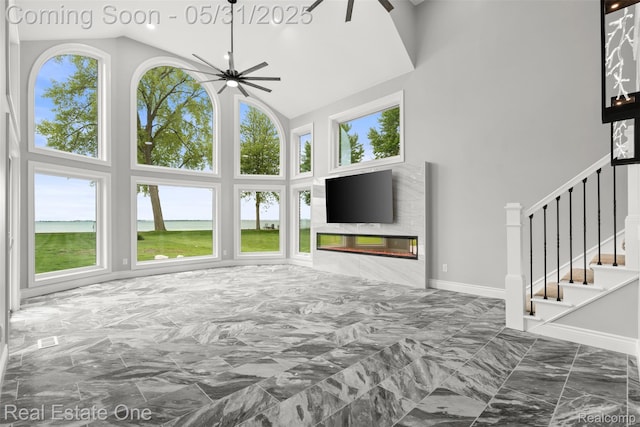 48556 Harbor Dr, Chesterfield, MI 48047 - unfurnished bedroom featuring marble tiled flooring, high vaulted ceiling, a glass covered fireplace, and baseboards