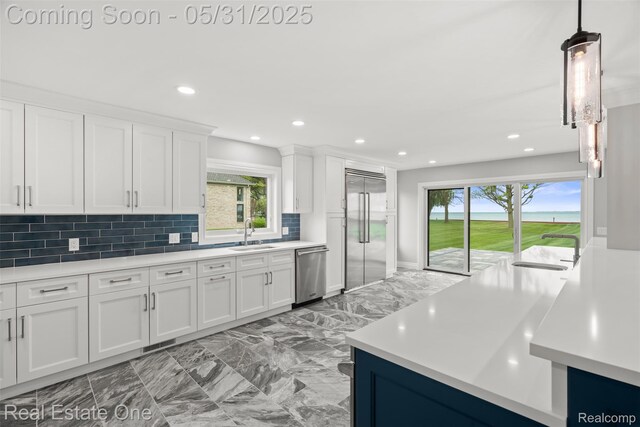 48556 Harbor Dr, Chesterfield, MI 48047 - kitchen with stainless steel appliances, light marble finish flooring, light countertops, a sink, and recessed lighting