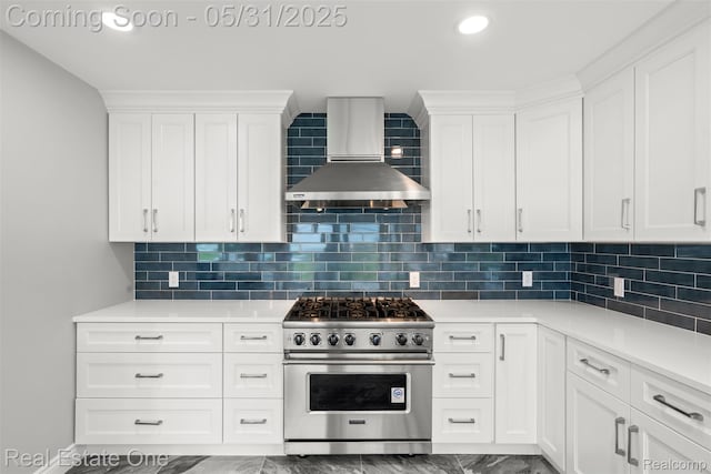 48556 Harbor Dr, Chesterfield, MI 48047 - kitchen featuring high end stainless steel range, wall chimney range hood, dark marble finish floors, white cabinetry, and light countertops