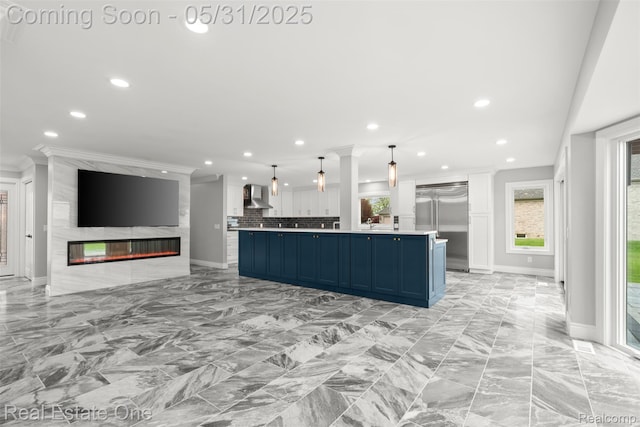 48556 Harbor Dr, Chesterfield, MI 48047 - kitchen with wall chimney exhaust hood, blue cabinetry, stainless steel built in refrigerator, open floor plan, and recessed lighting