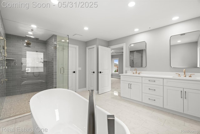 48556 Harbor Dr, Chesterfield, MI 48047 - bathroom featuring double vanity, a shower stall, a soaking tub, recessed lighting, and baseboards
