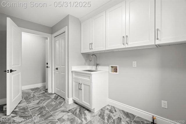 48556 Harbor Dr, Chesterfield, MI 48047 - washroom with washer hookup, baseboards, light marble finish flooring, and cabinet space