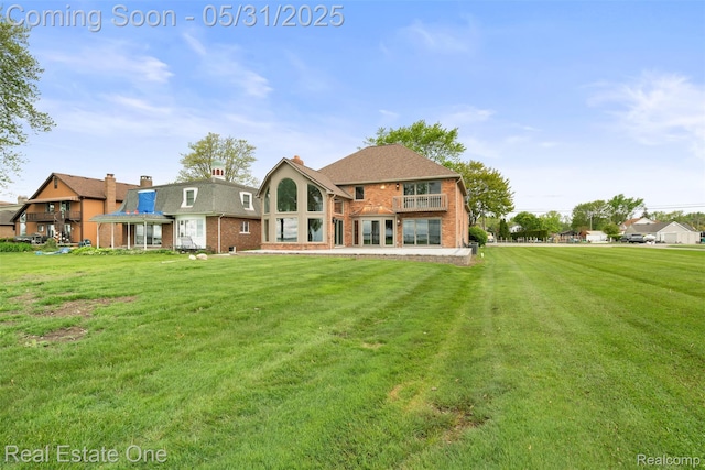 48556 Harbor Dr, Chesterfield, MI 48047 - rear view of house with a yard, brick siding, and a balcony