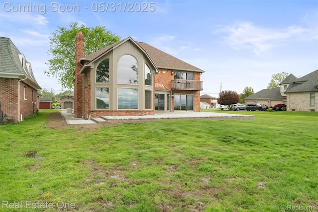 48556 Harbor Dr, Chesterfield, MI 48047 - back of property featuring a balcony, a lawn, a chimney, and brick siding