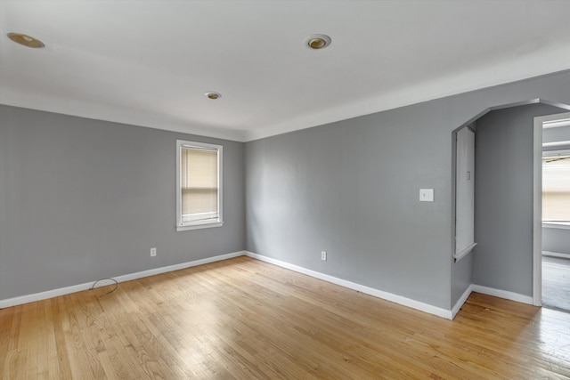 9035 Braile St, Detroit, MI 48228 - spare room featuring light wood finished floors, baseboards, and arched walkways