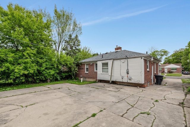 9035 Braile St, Detroit, MI 48228 - back of property featuring a chimney and brick siding