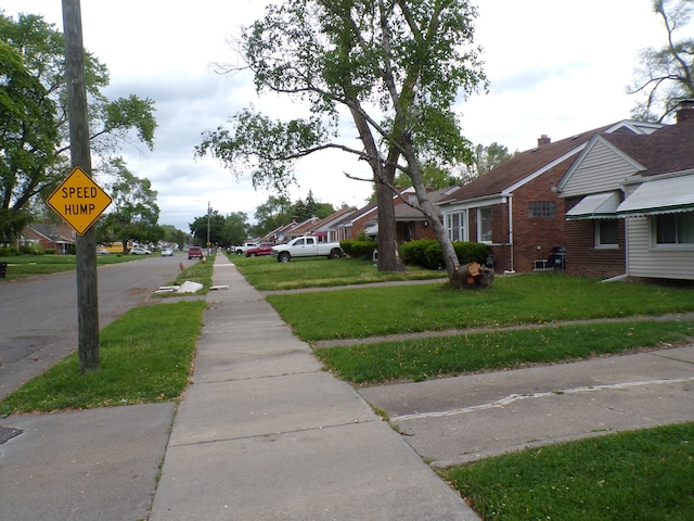 9546 Westwood St, Detroit, MI 48228 - view of asphalt road with sidewalks and traffic signs