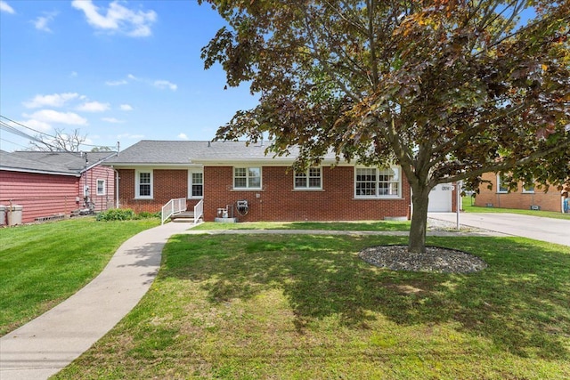 30617 Young Dr, Gibraltar, MI 48173 - single story home with brick siding, a front yard, and concrete driveway