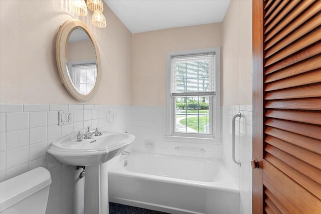 30617 Young Dr, Gibraltar, MI 48173 - bathroom with tile walls, toilet, a bath, and wainscoting