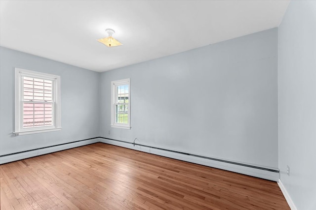 30617 Young Dr, Gibraltar, MI 48173 - empty room with wood finished floors, baseboards, and a baseboard radiator