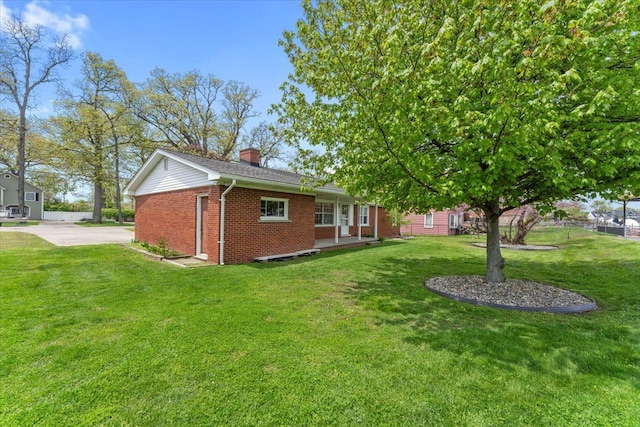 30617 Young Dr, Gibraltar, MI 48173 - view of front of house featuring brick siding, a chimney, and a front lawn