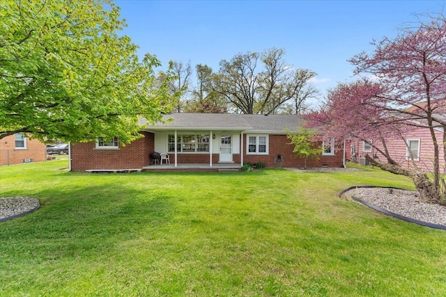 30617 Young Dr, Gibraltar, MI 48173 - ranch-style home featuring covered porch, a front yard, and brick siding