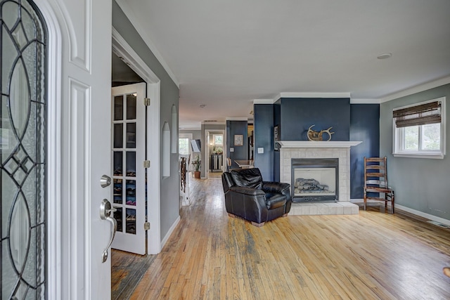2230 Princeton Rd, Berkley, MI 48072 - living room featuring hardwood / wood-style flooring, baseboards, ornamental molding, and a tile fireplace