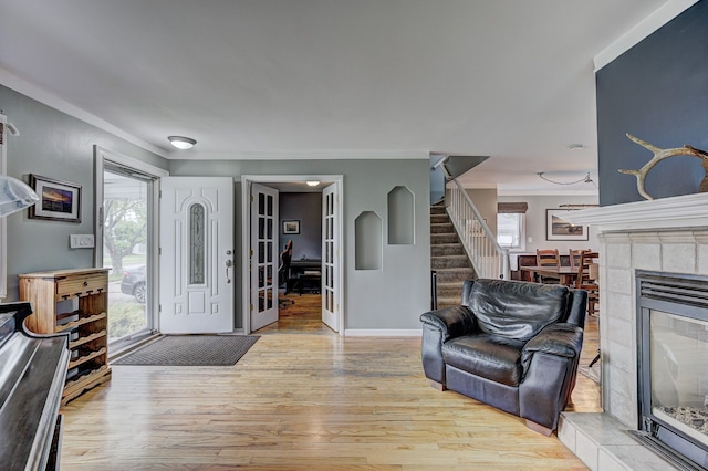 2230 Princeton Rd, Berkley, MI 48072 - entrance foyer featuring wood finished floors, stairs, baseboards, crown molding, and a fireplace