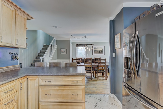 2230 Princeton Rd, Berkley, MI 48072 - kitchen featuring stainless steel refrigerator with ice dispenser, light brown cabinetry, light tile patterned flooring, and a peninsula