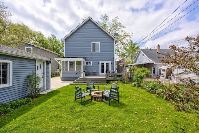 2230 Princeton Rd, Berkley, MI 48072 - back of property featuring a sunroom, an outdoor fire pit, and a wooden deck