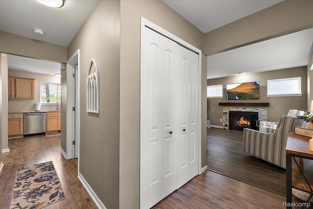 457 Cove View Dr, Waterford, MI 48327 - hall with a sink, dark wood-style floors, and baseboards