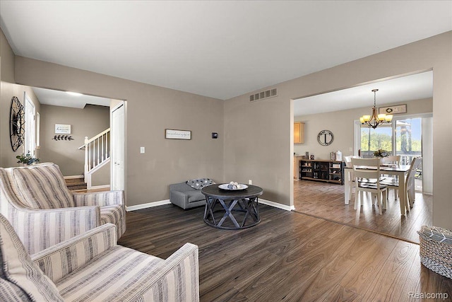 457 Cove View Dr, Waterford, MI 48327 - living area featuring wood finished floors, a chandelier, stairs, and baseboards