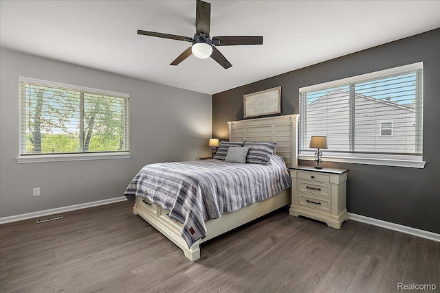 457 Cove View Dr, Waterford, MI 48327 - bedroom with multiple windows, dark wood-style floors, and baseboards