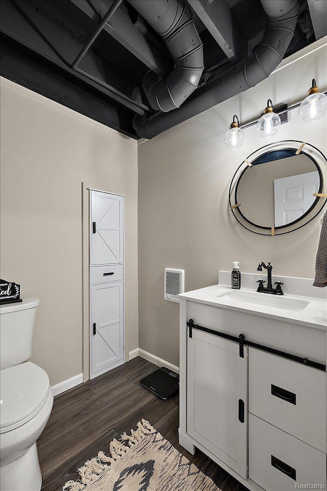 457 Cove View Dr, Waterford, MI 48327 - bathroom with vanity, toilet, wood finished floors, and baseboards