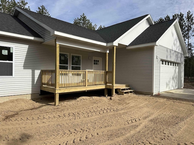 5203 NE Myers Rd, Kalkaska, MI 49646 - view of front of home with a garage, driveway, a porch, and a shingled roof