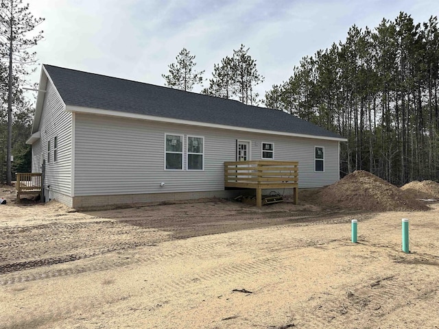5203 NE Myers Rd, Kalkaska, MI 49646 - back of property featuring a deck and a shingled roof