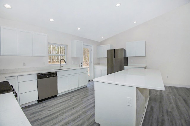 5203 NE Myers Rd, Kalkaska, MI 49646 - kitchen featuring appliances with stainless steel finishes, a sink, light wood-type flooring, lofted ceiling, and white cabinetry