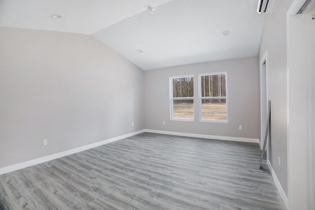 5203 NE Myers Rd, Kalkaska, MI 49646 - empty room with vaulted ceiling, wood finished floors, baseboards, and recessed lighting