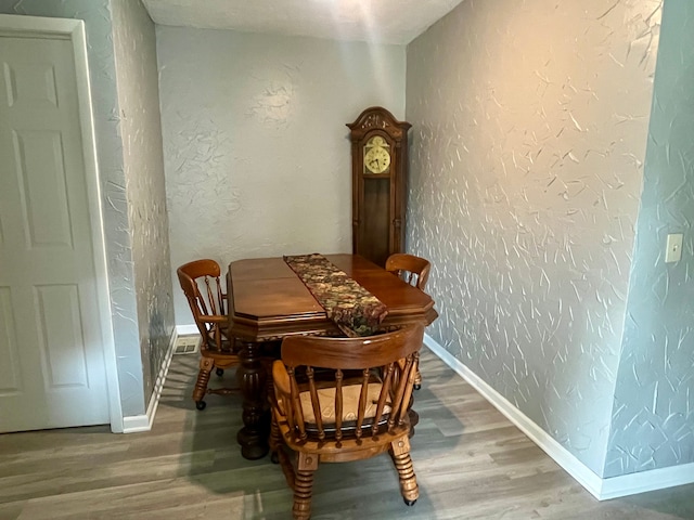 11855 Temperance St, Mount Morris, MI 48458 - dining room with a textured wall, wood finished floors, and baseboards