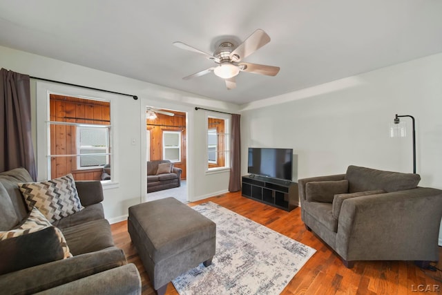 1107 Sunset Dr, Tecumseh, MI 49286 - living room with a ceiling fan, plenty of natural light, wood finished floors, and baseboards