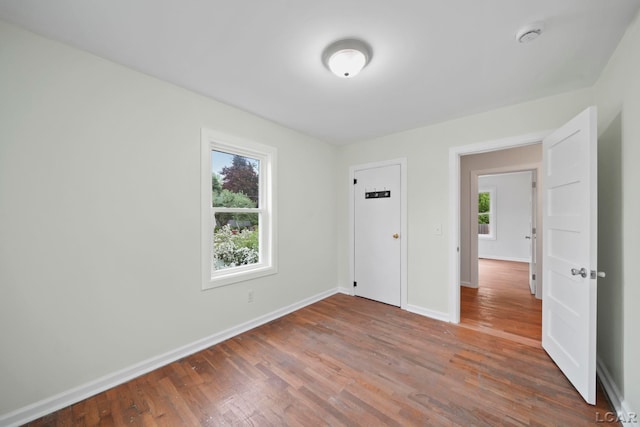 1107 Sunset Dr, Tecumseh, MI 49286 - unfurnished bedroom featuring wood finished floors and baseboards