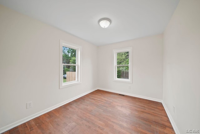 1107 Sunset Dr, Tecumseh, MI 49286 - spare room featuring wood finished floors and baseboards
