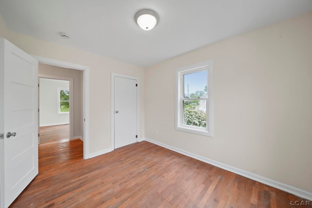 1107 Sunset Dr, Tecumseh, MI 49286 - unfurnished bedroom featuring baseboards, wood finished floors, and a closet