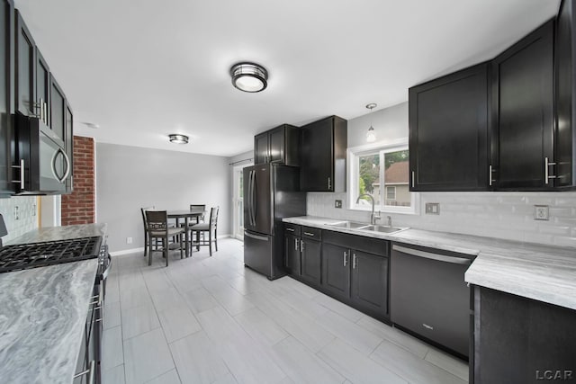 1107 Sunset Dr, Tecumseh, MI 49286 - kitchen featuring stainless steel appliances, a sink, decorative backsplash, and light countertops