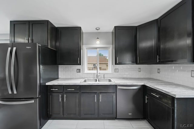 1107 Sunset Dr, Tecumseh, MI 49286 - kitchen featuring appliances with stainless steel finishes, a sink, backsplash, and light countertops