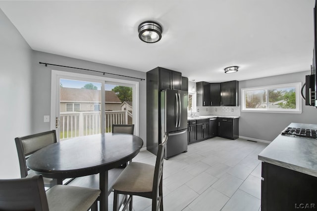 1107 Sunset Dr, Tecumseh, MI 49286 - dining room with plenty of natural light, baseboards, and light tile patterned floors