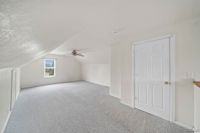 1107 Sunset Dr, Tecumseh, MI 49286 - additional living space with carpet flooring, vaulted ceiling, a ceiling fan, and baseboards