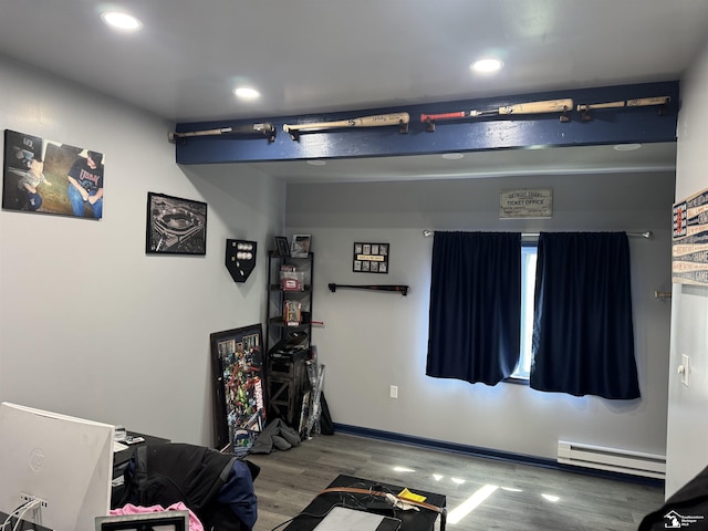 recreation room with baseboard heating, wood finished floors, recessed lighting, and baseboards