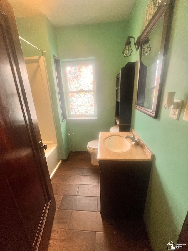 bathroom featuring toilet, vanity, bathtub / shower combination, and tile patterned floors