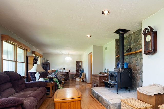 34699 Fuerstenau Rd, Richmond, MI 48062 - living area featuring wood finished floors, a wood stove, and a textured ceiling