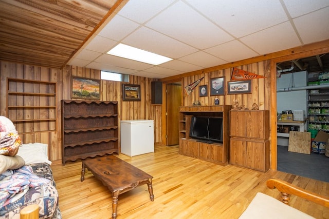 34699 Fuerstenau Rd, Richmond, MI 48062 - living area featuring wooden walls, light wood-style floors, and a paneled ceiling