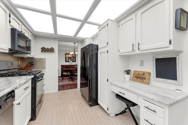 28605 Southpointe Rd, Grosse Ile, MI 48138 - kitchen with black appliances, a chandelier, white cabinets, backsplash, and light wood-type flooring