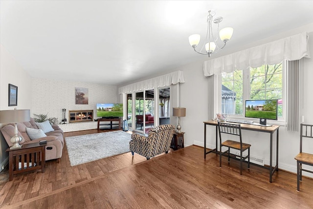 28605 Southpointe Rd, Grosse Ile, MI 48138 - living room featuring wood finished floors, a chandelier, and baseboards