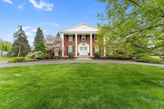 28605 Southpointe Rd, Grosse Ile, MI 48138 - neoclassical home with a front lawn, curved driveway, and brick siding