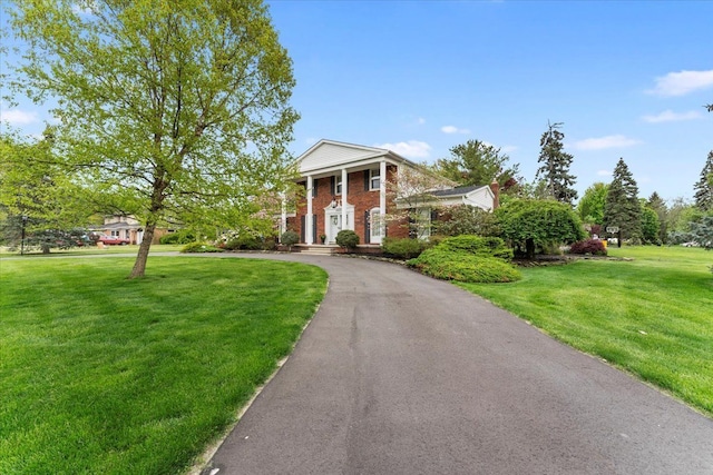 28605 Southpointe Rd, Grosse Ile, MI 48138 - neoclassical home featuring brick siding, a front yard, and asphalt driveway