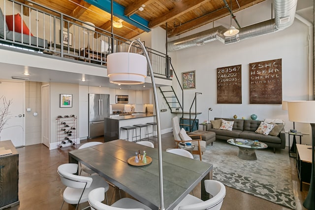 3434 Russell St Unit 28-205, Detroit, MI 48207 - dining room featuring wooden ceiling, a towering ceiling, stairs, concrete flooring, and beam ceiling
