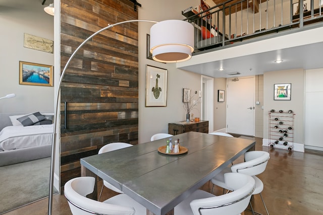 3434 Russell St Unit 28-205, Detroit, MI 48207 - dining area featuring a towering ceiling and finished concrete floors