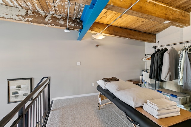 3434 Russell St Unit 28-205, Detroit, MI 48207 - bedroom with wood ceiling, baseboards, carpet flooring, and beam ceiling