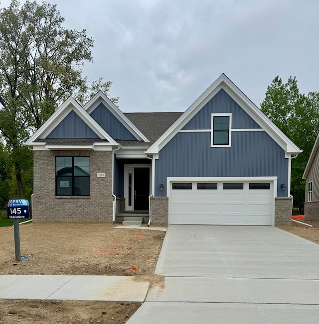 7783 Arimoore Dr, West Bloomfield, MI 48322 - craftsman house with concrete driveway, a garage, board and batten siding, and brick siding
